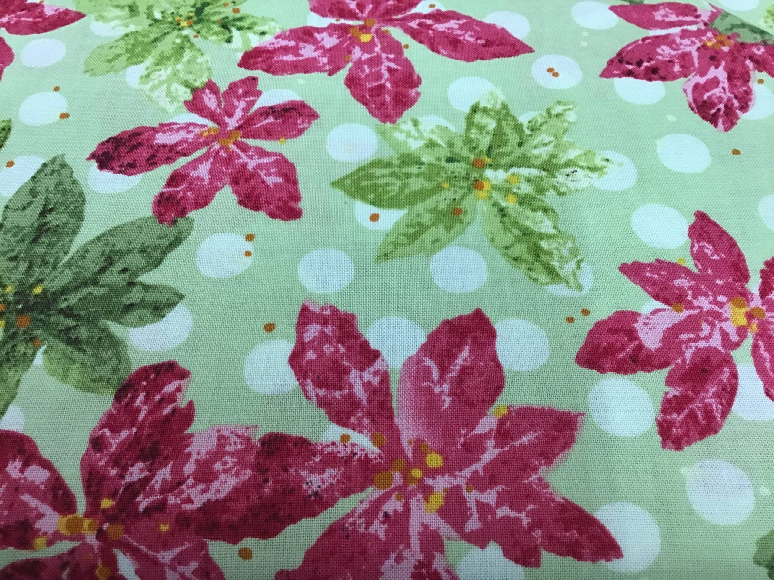 NANCYS HOLIDAY FAVOURITES Poinsettia red on green fabric NANCYS HOLIDAY FAVOURITES Poinsettia red on green fabric