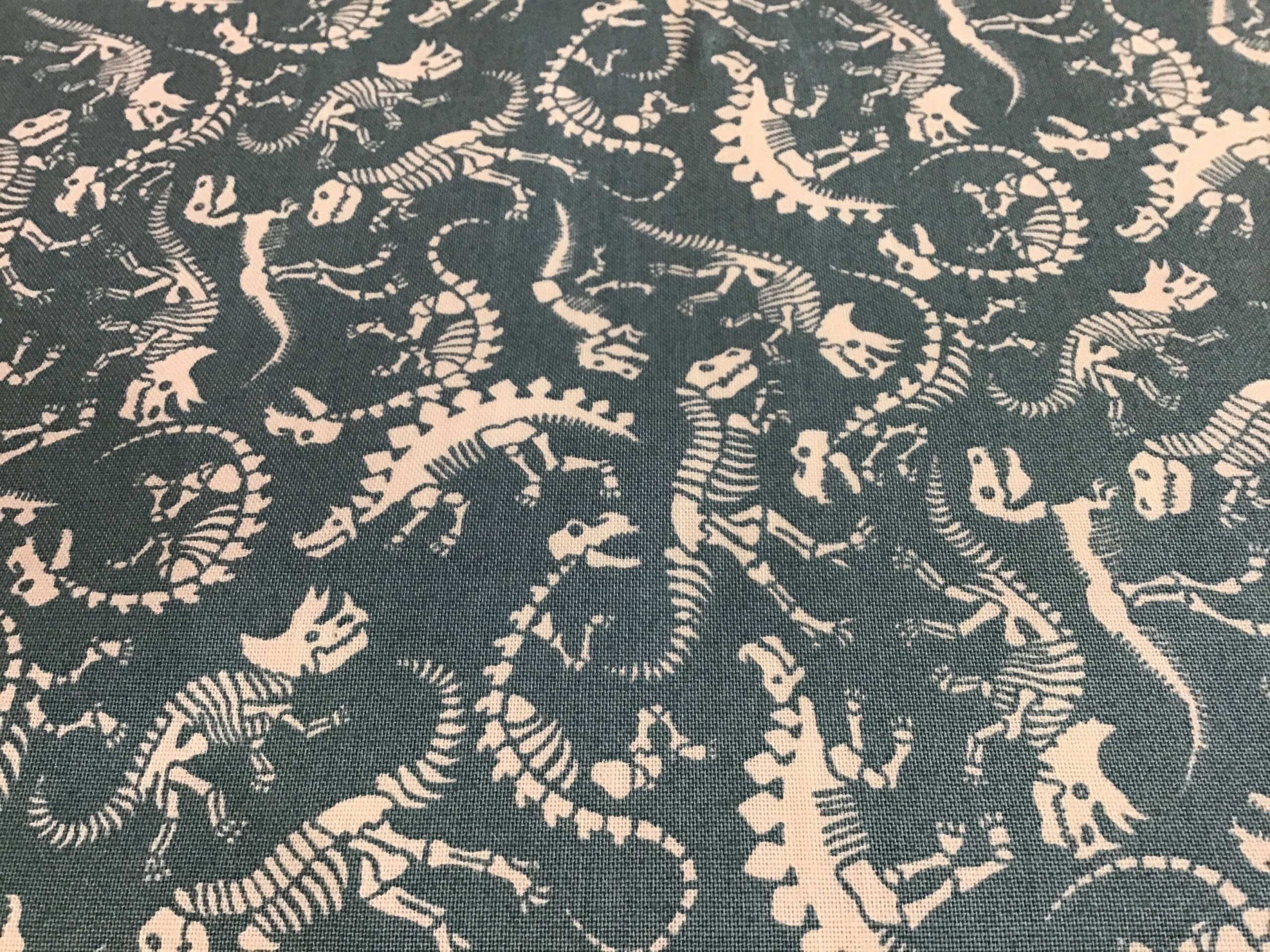 REX DINO SCATTER skeletons on blue fabric REX DINO SCATTER skeletons on blue fabric