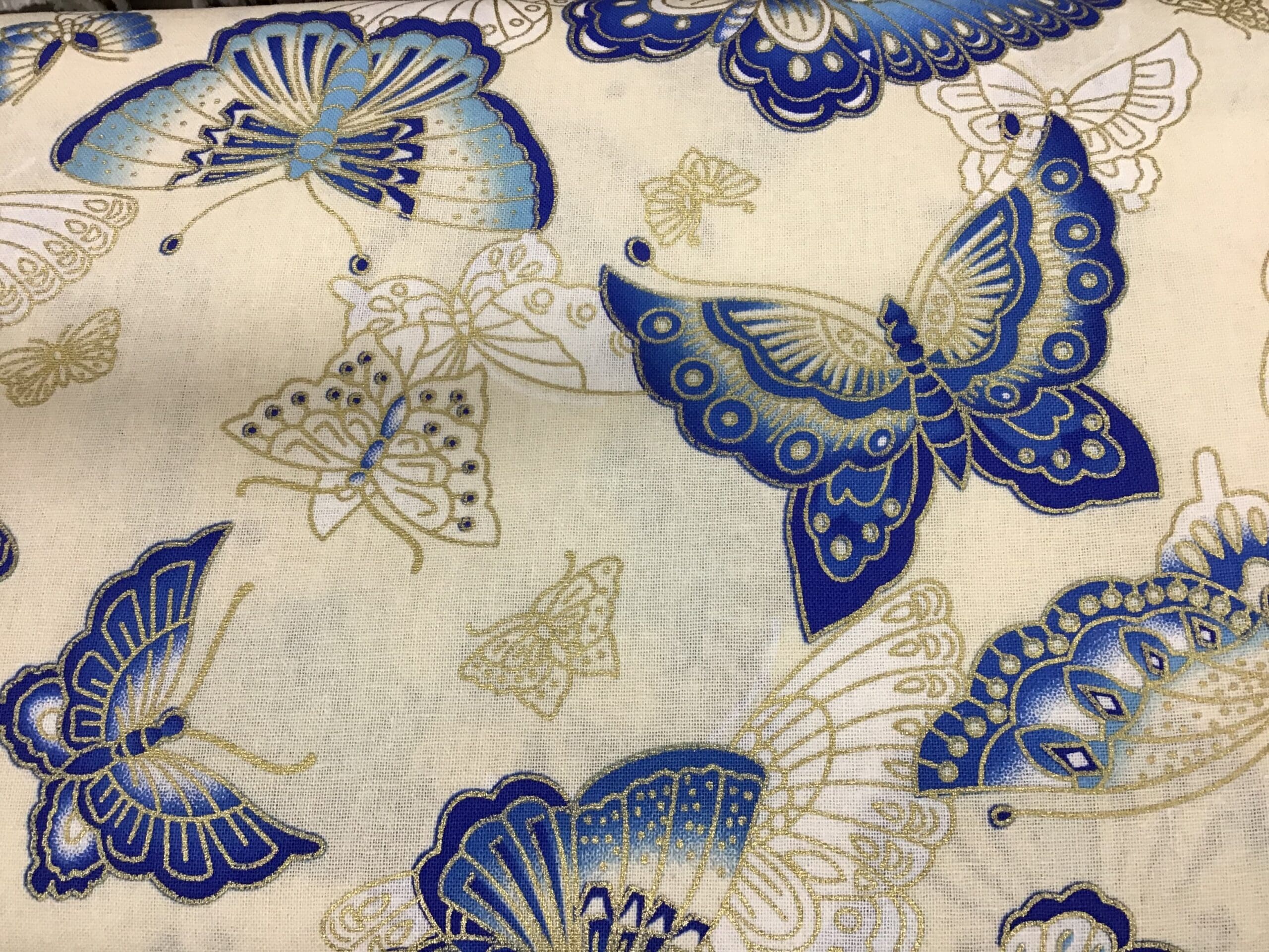 Butterflies PO2361 Blue gold on cream fabric. 54” wide Butterflies PO2361 Blue gold on cream fabric. 54” wide