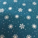 Craft Cotton Christmas print – 126 gold snowflake on dark green background by Reynard