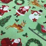 Craft Cotton – Merry and Bright –  C8390 Santa on green background by Reynard