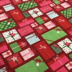 Craft Cotton – Merry and Bright –  C8392 Christmas presents on red background by Reynard